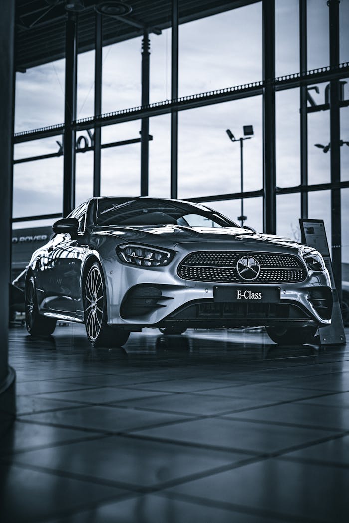 A stylish silver Mercedes E-Class displayed indoors, perfect for automotive enthusiasts.